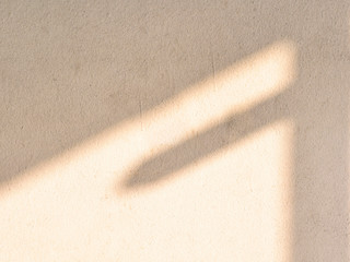 Sunset drop shadow on old white concrete wall. 
