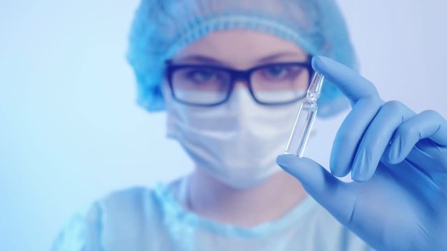 Respiratory illness prevention. Vaccine hesitancy. Female doctor shaking ampoule with drugs.