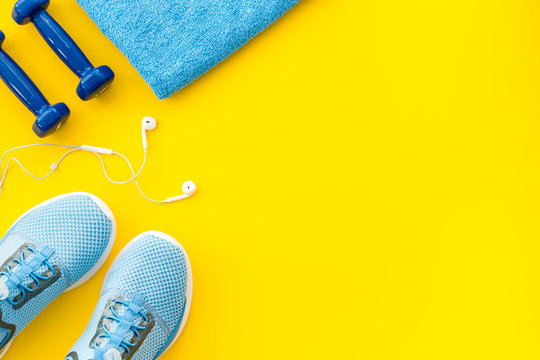 Sport Flat-lay With Sheakers And Water On Yellow Table Top View Copy Space