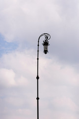 forged old lantern against the sky with clouds