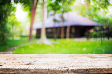 Blurred background of home garden picnic and wooden table free space for product display.