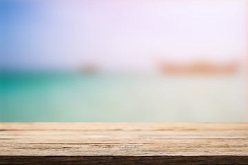 Wooden desk space over summer sea side sunny day background. Product display montage