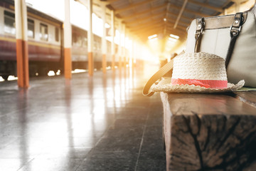 A red hat and bag on a chair at train station.travel concept