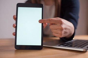 Close up of woman finger pointing on a blank tablet screen