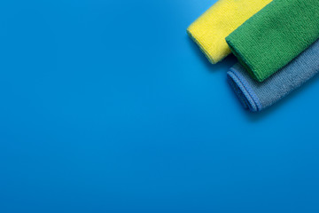 Three Colorful, dry microfiber cloths for different surfaces cleaning in kitchen, bathroom and other rooms.