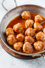 Meatballs with tomato sauce in a pan. Selective focus. Close up.