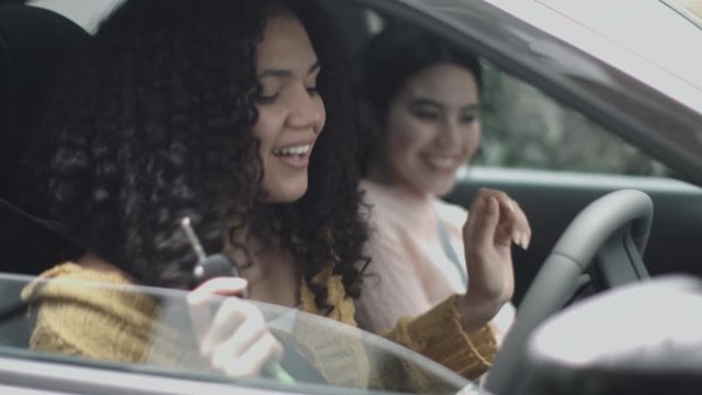 Excited young woman in new car