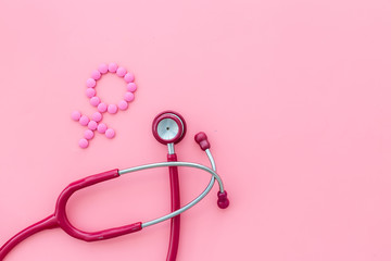 Fototapeta premium Women's Health issues. Medical concept with Venus sign and stethoscope on pink background top-down copy space