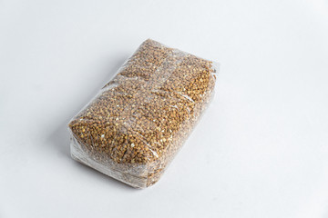 buckwheat in the plastic packet under the white background