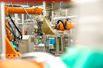 use of robotic arms in the production of cars in the automotive industry