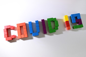 topic COVID-19 text message from wooden block toy of kid on white background