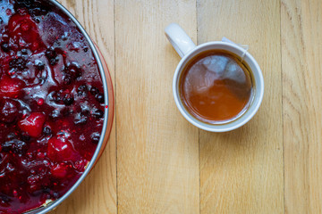 cup of tea with cheesecake on wooden background