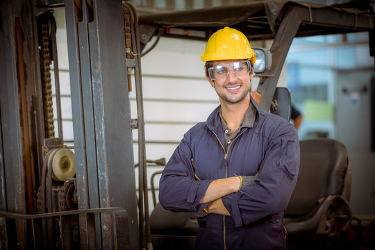 Portrait Industrial worker wearing safety uniform and safe helmet for work and control machines  with industry factory background.