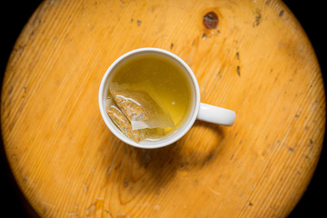 cup of tea on round wooden background