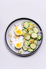 Easy vegetarian salad with cucumber, onion and eggs with vinaigrette sauce. Healthy nutrition. Selective focus
