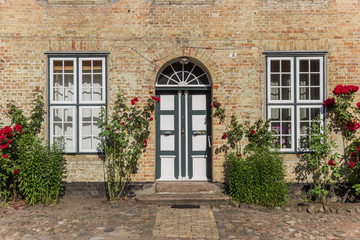 Fototapeta na wymiar Entrance to the historic monastery in Holm village of Schleswig, Germany