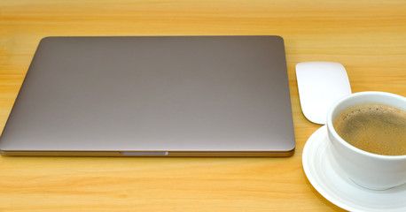 workplace. Wooden desk with laptop and coffee cup. designer working place