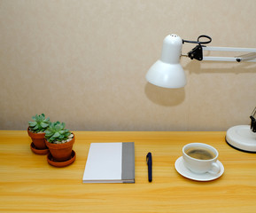 workplace. Wooden desk with laptop and coffee cup. designer working place