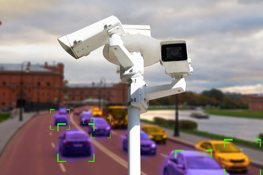 The concept of video surveillance and security technology. CCTV camera on the background of a road bridge with traffic in cloudy weather. Definition zone