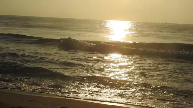 beach with sunset background. The sun over sea. Amazing red sunrise on beach palms island. Orange colors sunrise and waves. Nature sun sunrise palms beach background. Yellow sky, beautiful palm trees 