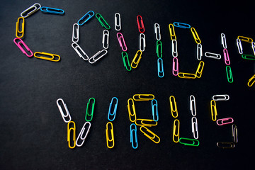 Covid-19 virus with colored paper clips on a black background