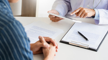 Technology in medicine and health care, Doctor consultation Discussing Records with the patient by using digital tablet in doctors office