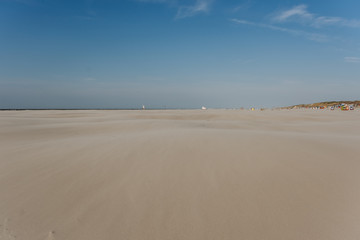 Fototapeta na wymiar wide beach landscape on a sunny day with blue sky in summer