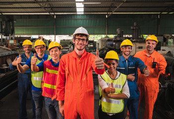 The industrial worker team in a large industrial factory with many equipment.