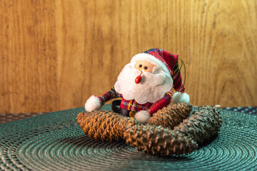 Santa Claus amid pine cones and Christmas motifs