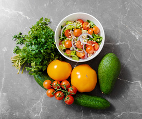 Healthy salad on a kitchen table, view from above