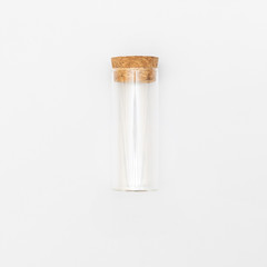 top view of transparent empty glass jar or test tube bottle with closed brown cork cap lids on white background