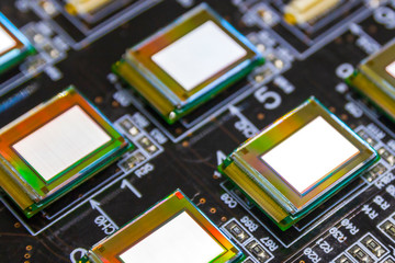 Several microdisplays bright of white color on the test station. Monitors glow brightly of white...