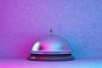 silver hotel bell in pink-blue lighting