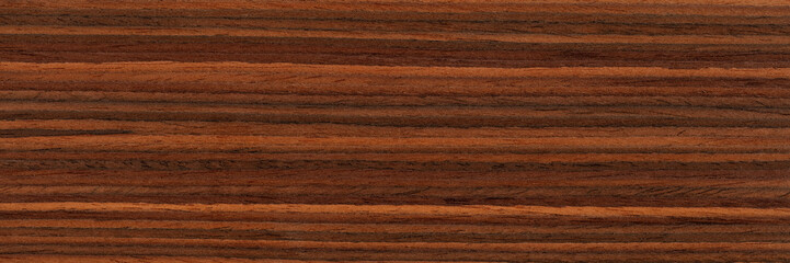 Elegant natural rosewood veneer background in brown color. Natural wood texture, pattern of a long veneer sheet, plank.