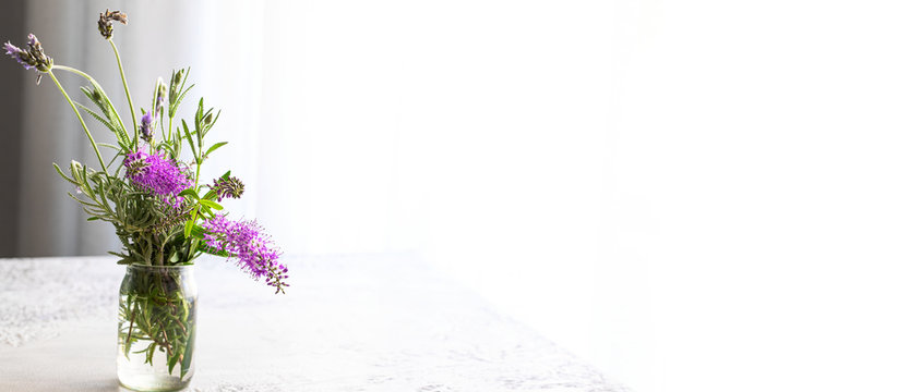 Fresh lavender flower bouquet in vase on the table.Large image dor banner