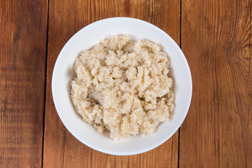 Top view of barley porridge on dish on rustic table