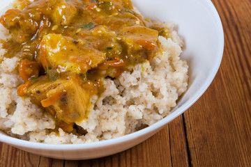 Bowl of barley porridge with meat sauce, fragment close-up