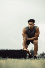 Muscular man taking break from cross training