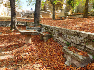 Autumn Park in San Marino. A cozy park with stone benches and a table on a sunny, autumn day.