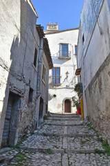 Fototapeta na wymiar A narrow street between the old houses of Castelvetere sul Calore, village in the province of Avellino, Italy