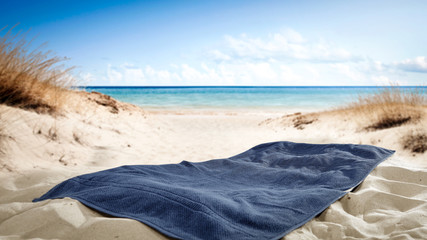 Towel on sand and free space for your decoration. 