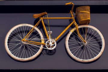 Fototapeta na wymiar Vintage bicycle hanging on the wall as an element of design