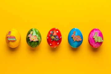 Bright easter eggs with bunny (rabbit) on yellow background. Retro colorful spring decoration.