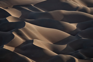 Sunset wiev of abstract giant patterns in the dunes of  Rub’ al  Khali.