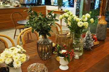 Flower arrangement and decoration on wooden table