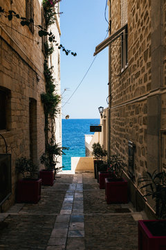 narrow street in old town in Ermupoli, Syros island (Greece))