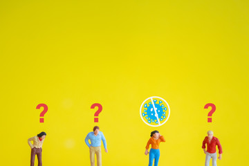 Miniature figure of woman who clean from infection of pandemic corona virus or covid-19 on yellow background, unknown suspicious people with question marks.Social distancing concept