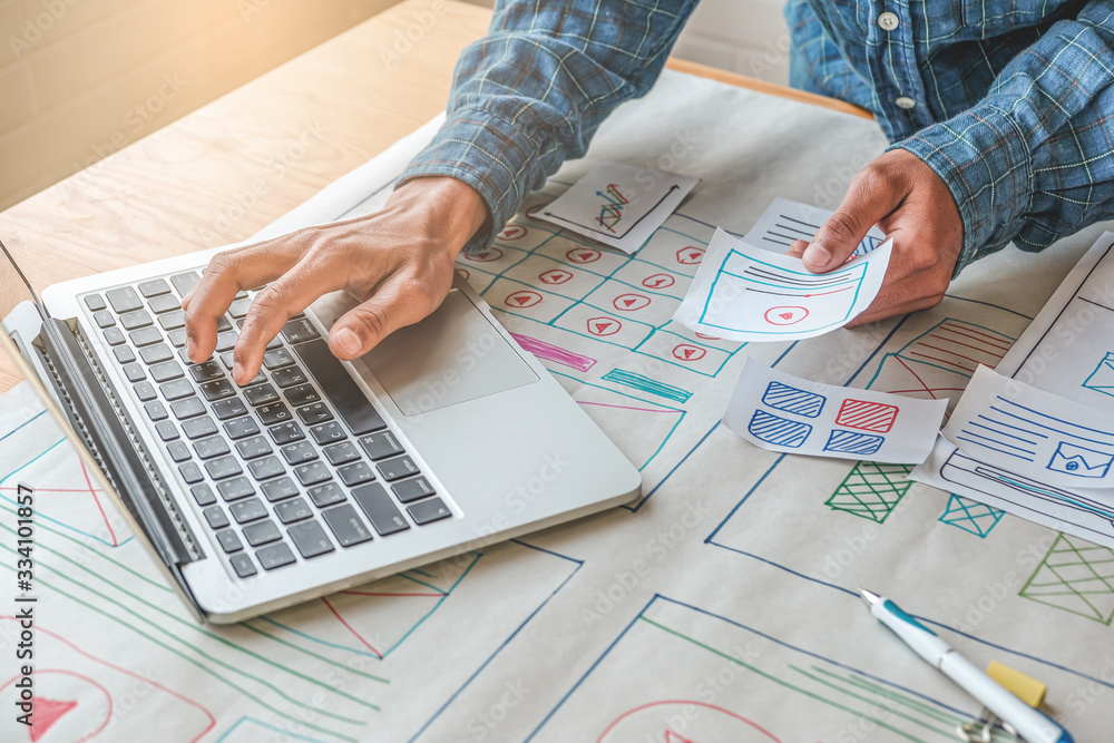 Poster close up male asian ui/ux designer working and designing a user interface for website and applicatio