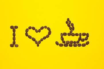 I love Coffee written with brown coffee beans on yellow background