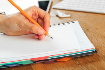 Female hands working on wooden work place with modern gadgets  - Image